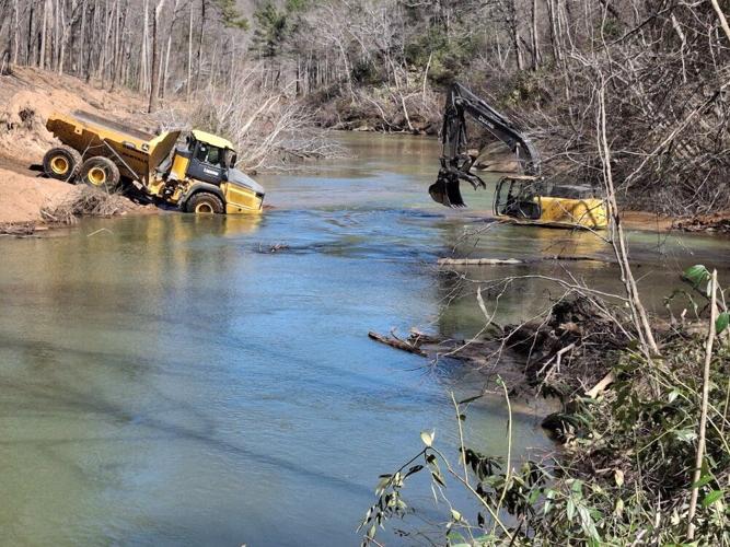 This photo from Conserving Carolina shows Heavy equipment being used for hurricane debris cleanup in the Green River in Polk County. Burke is in the planning stages of its stream debris removal.