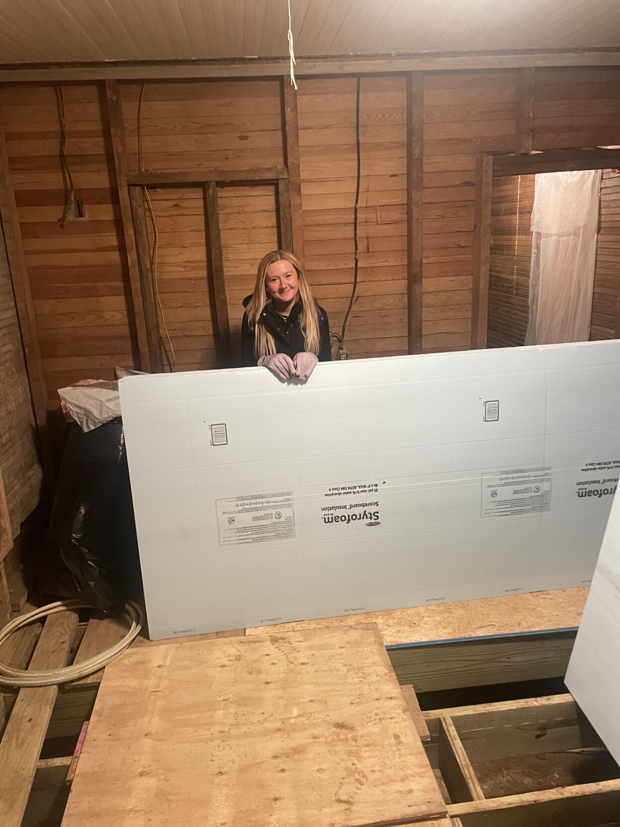 Holland pausing for a photot before installing dyrwall sheets in a home repair.