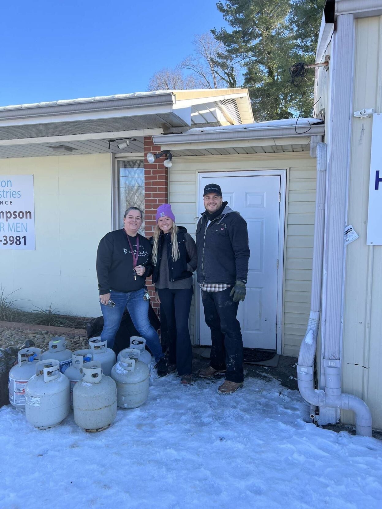 Madison Holland (middle) seen delivering propane fuel to local residents in Black Mt. NC.
