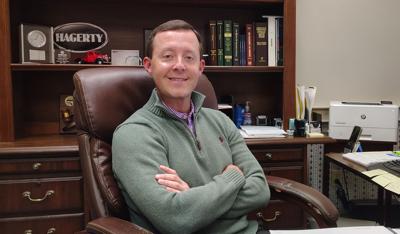 Dalton Walters sits behind his desk at Mimosa Insurance Agency