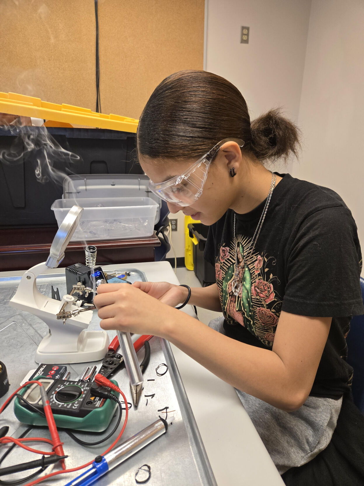 NCSDs Kenia Cardoza, uses a soldering iron to solder wires and electrical connections to prepare and troubleshoot her teams drone for competition.
