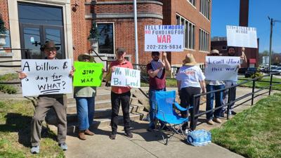 Protestors stand outside U.S. Rep. Tim Moore's office