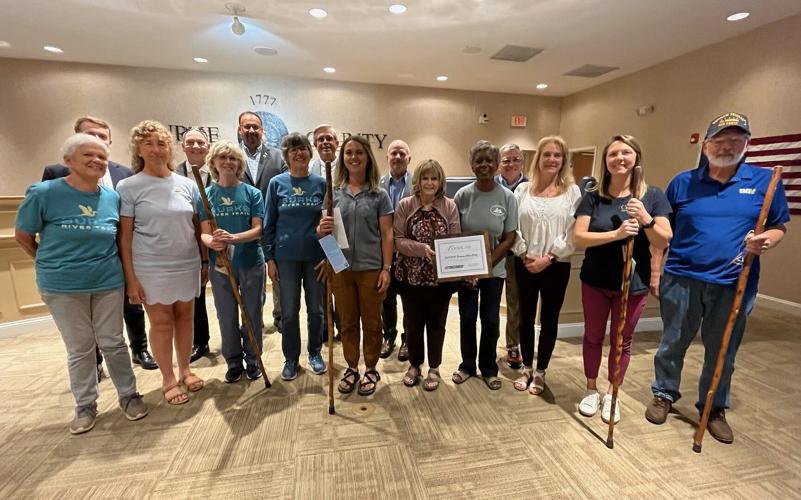 The Burke County Board of Commissioners stands behind winners of the Burke Chamber's annual Spring Litter Sweep. The Burke River Trail Litter Gitters, left, took first place, and were followed in the top three by former three-time winner Gary Jennings, ...