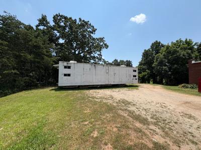 A temporary housing unit made from a converted Norfolk Southern rail car sets outside the Marshallese New Beginnings Church in George Hildebrand. Members of nine Marshallese families will take turns staying in the unit while contractors bring their apar...