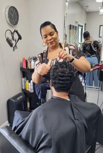 Felecia Maddox works on a client's hair