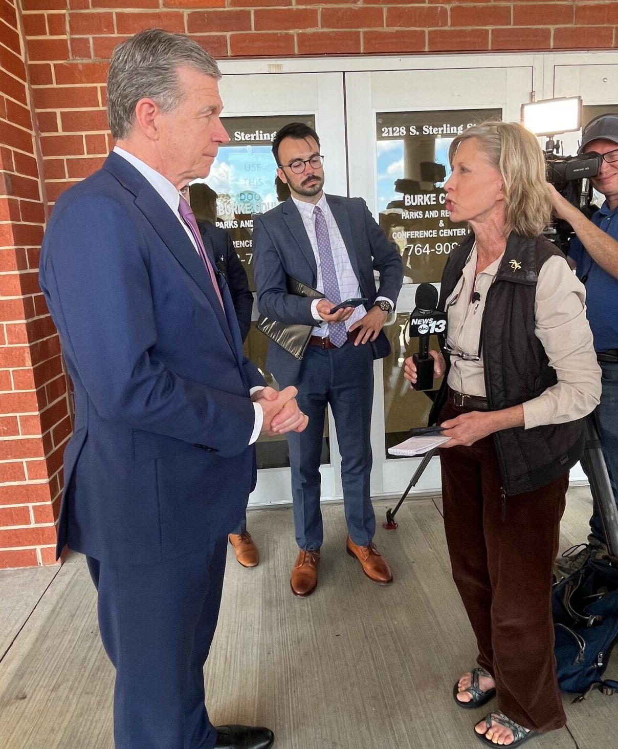 North Carolina Governor Roy Cooper speaks with reporters outside the Foothills Higher Education Center last Friday. He was in town for a meeting with county and municipal leaders from all across Western North Carolina.