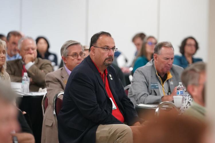 Burke County Commissioners Randy Burns, center, and Jeff Brittain, left, listen intently during last Friday's meeting with state and federal officials concerning recovery from Hurricane Helene at the Foothills Higher Education Center in Morganton.