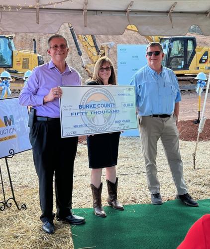 Burke Animal Services Foundation President Kay Draughn and Vice President Alan Wood, right, present a check for $50,000 to help with construction of the county's new Animal Services Building prior to a groundbreakin ceremony last Friday.