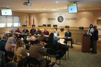 Burke Board of Commissioners members and other listen as A. Toni Young, founder and executive director of Community Education Group talks about strategies to combat the opioid crisis with funds from the national opioid lawsuit settlement during a meetin...