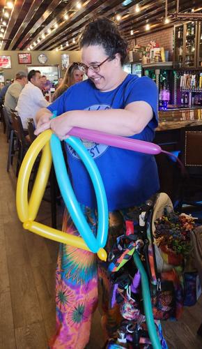 Becki the Balloon Lady works on a giant balloon hat