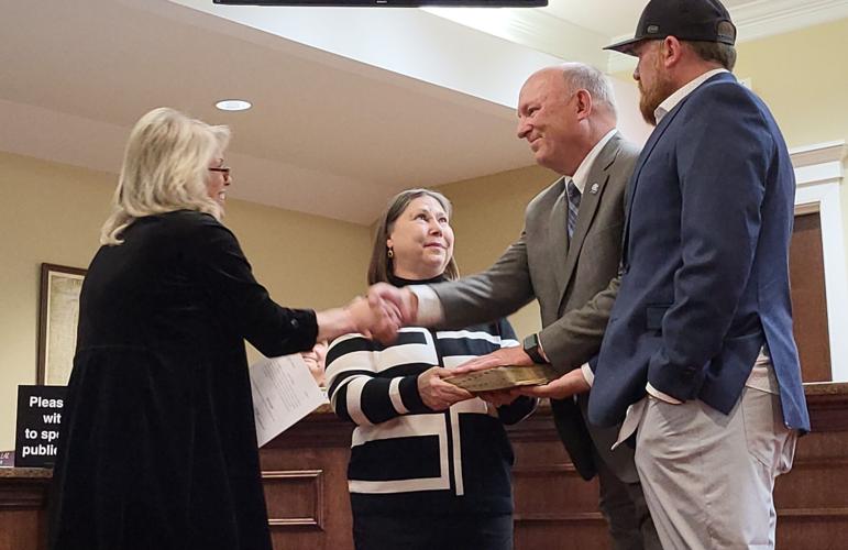 Keith Huffman is sworn into office alongside his wife and son