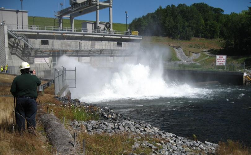 A FERC inspector takes readings near the powerhouse on Lake James.