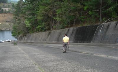 An inspector walks on the Paddy Creek chute spillway at Lake James.