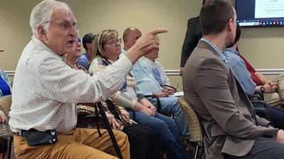 Former Valdese Councilman Glenn Harvey addresses the mayor from his chair