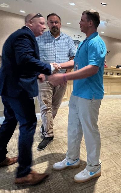 Burke County Commissioners Mike Stroud, left, and Randy Burns, center, shake hands with Chris Otstott after Otstott told his story of recovery from addiction during Monday's pre agenda meeting The commissioners will decide whether to fund the Burke Reco...