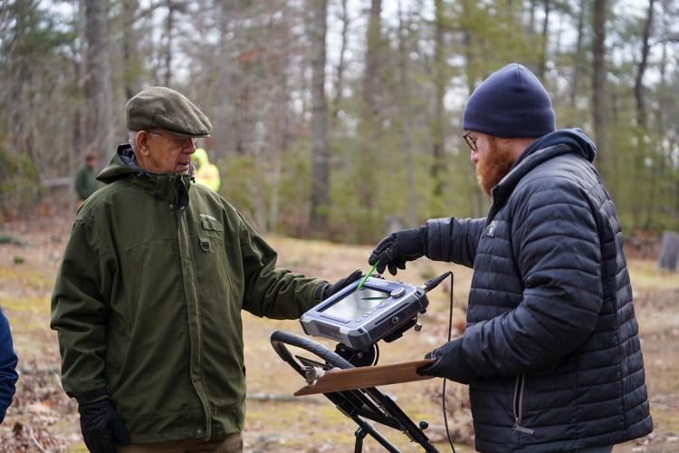 Geophysical archeologist Donnie Rowe points out the probable location of an unmarked grave to Allen Fullwood at Rock Hill Cemetery Thursday.