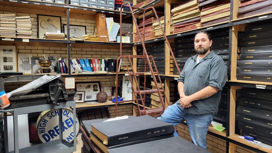 Corwin Keys stands in the museum's newspaper archive