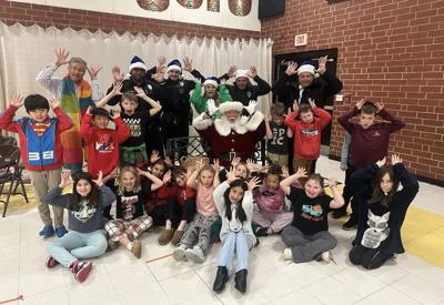Kids at Valdese Elementary School pose for a fun picture with Santa and Valdese Police Department officers