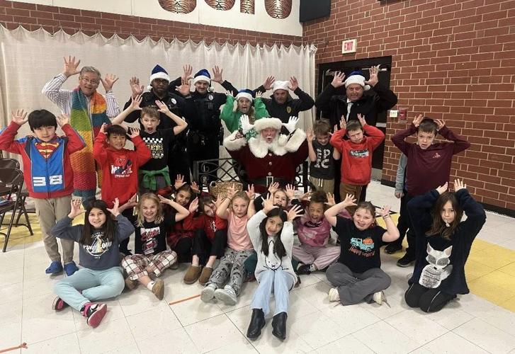 Kids at Valdese Elementary School pose for a fun picture with Santa and Valdese Police Department officers