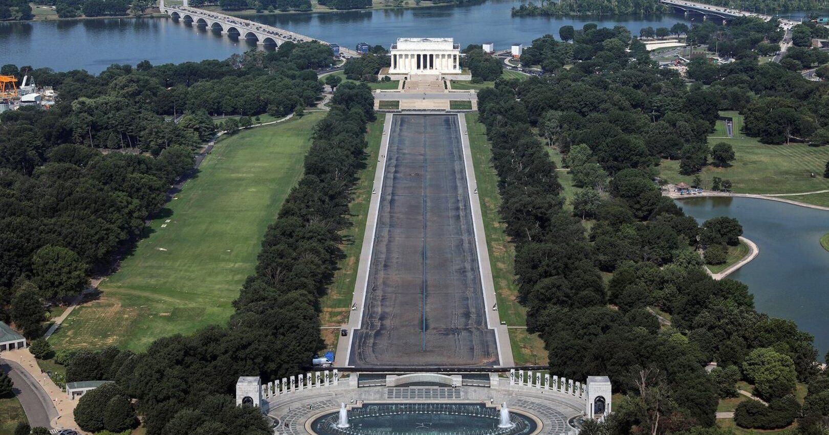 Drained Reflecting Pool reveals Trump American flag blue liner is now closer to gray