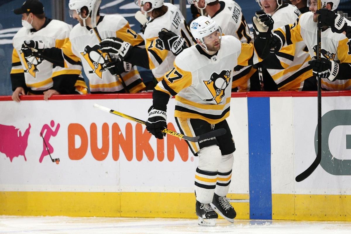 Pittsburgh Penguins' Bryan Rust (17) celebrates his goal with Jake