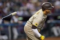 Former Arizona Diamondbacks players Luis Gonzalez, right, and Randy Johnson  wave to fans during the team's 25th anniversary ceremony prior to a baseball  game against the San Diego Padres, Saturday, Aug. 12