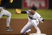 Milwaukee Brewers first baseman Rowdy Tellez, right, reaches out to catch a  throw to first base to get Arizona Diamondbacks' Alek Thomas (5) out during  the sixth inning of a baseball game