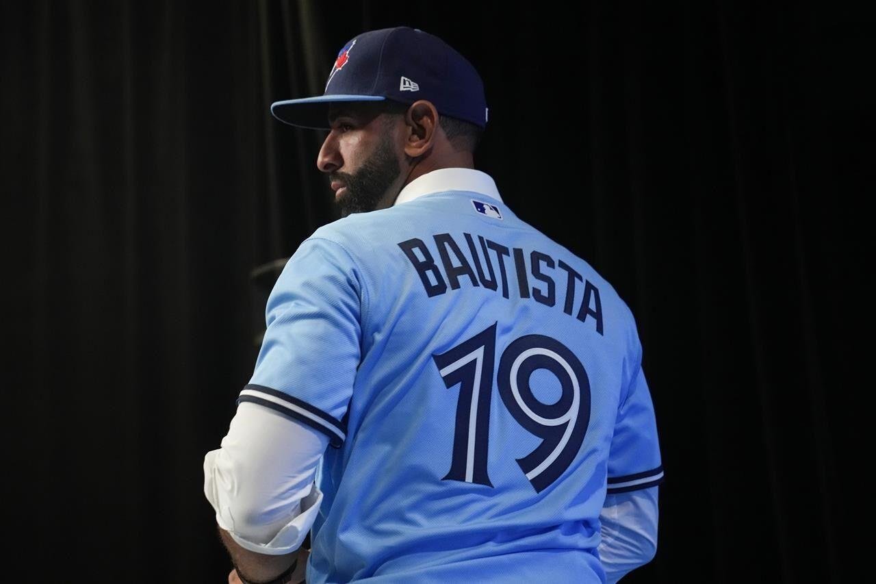 Jose Bautista of the Toronto Blue Jays wears the new red jersey