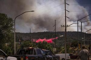 Cooler temps and rain could help corral blazes that forced thousands to flee New Mexico village