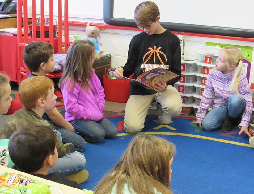 SMS basketball players read to elementary students