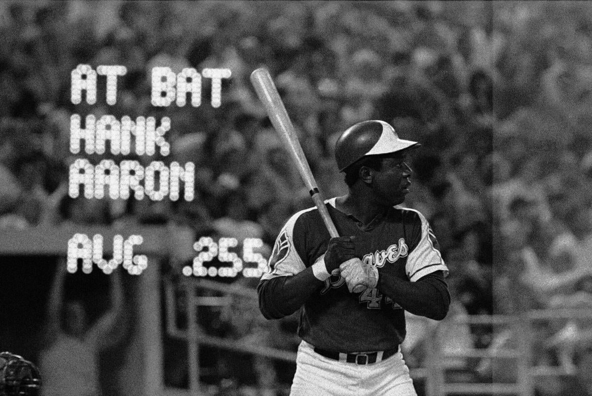 Milwaukee Braves outfielder Hank Aaron, center, jokes with St. Louis  Cardinals players Wally Moon, left, and Stan Musial before start of game  between the Cardinals and the Braves at Busch Stadium in