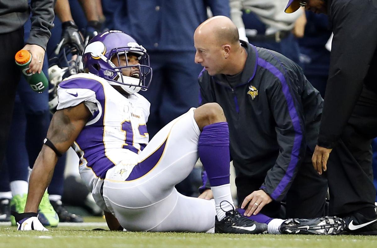 Head athletic trainer Eric Sugarman attends to Minnesota Vikings receiver Percy Harvin (12) in the third quarter. The Seattle Seahawks beat the Minnesota Vikings, 30-20, at CenturyLink Field in Seattle, Washington on Sunday, November 4, 2012.