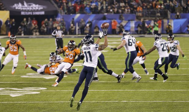 Seattle Seahawks wide receiver Percy Harvin (11) runs the opening kick off  of the second half for a 87 yard touchdown at the Super Bowl XLVIII at  MetLife Stadium in East Rutherford