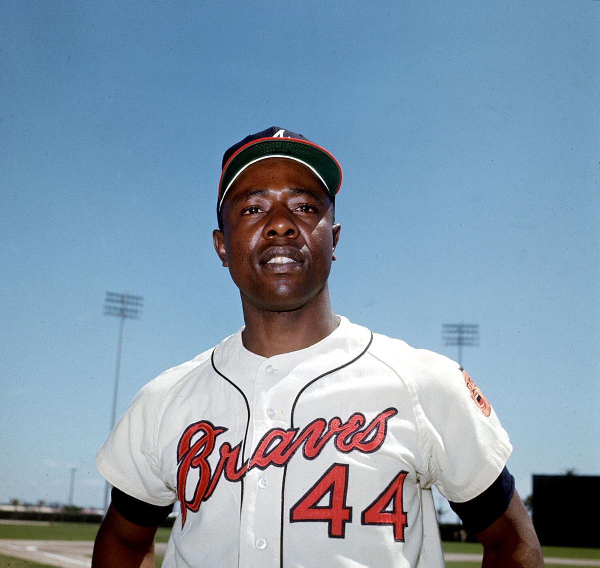 Milwaukee Braves outfielder Hank Aaron, center, jokes with St. Louis  Cardinals players Wally Moon, left, and Stan Musial before start of game  between the Cardinals and the Braves at Busch Stadium in