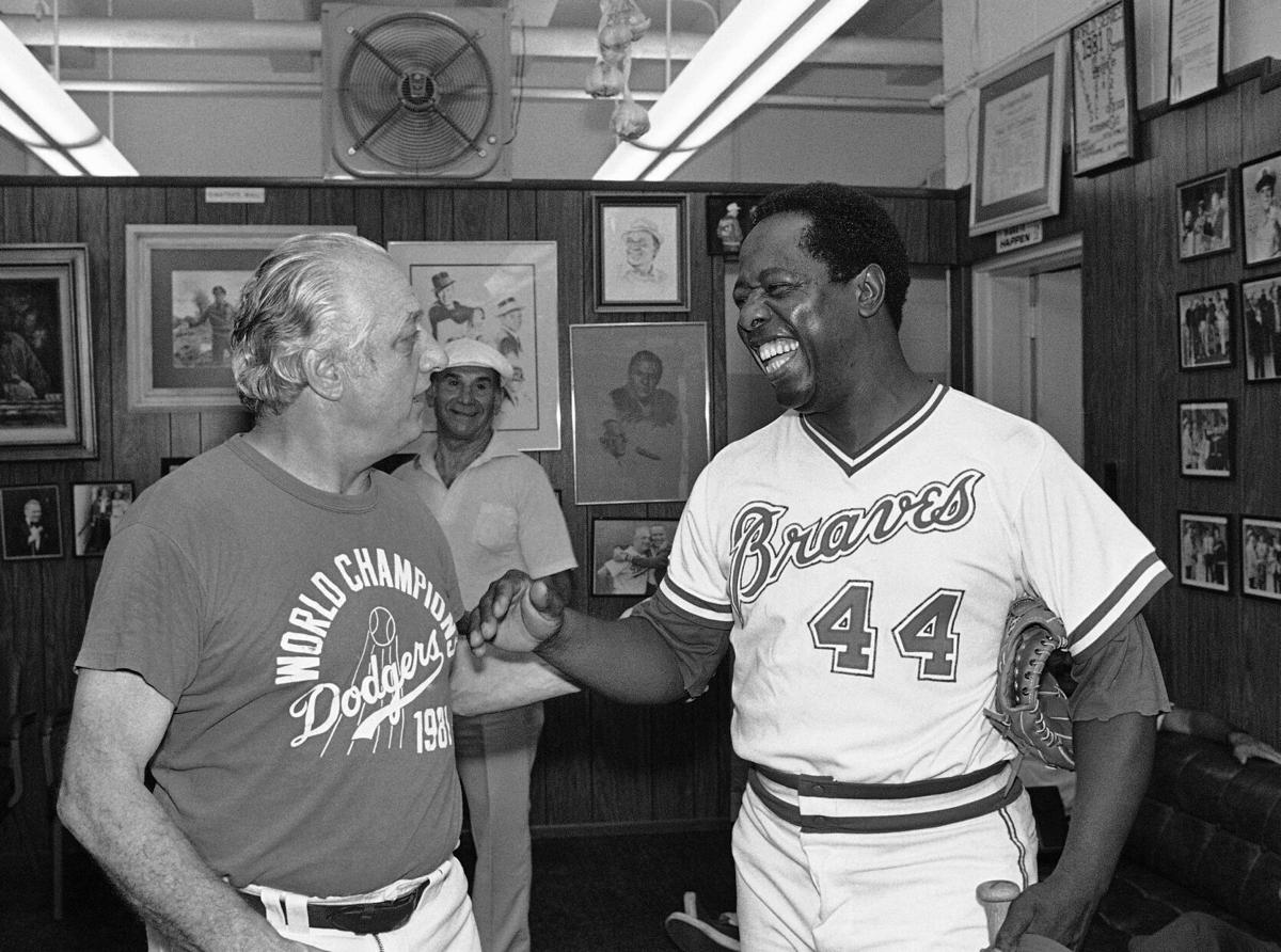 Milwaukee Braves outfielder Hank Aaron, center, jokes with St. Louis  Cardinals players Wally Moon, left, and Stan Musial before start of game  between the Cardinals and the Braves at Busch Stadium in