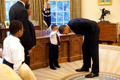 Obama congratulates boy who touched his head in iconic photo on graduating high school