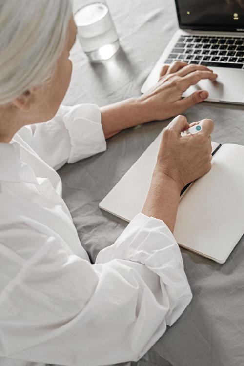 _an-elderly-woman-taking-notes-while-using-a-laptop-4057764_CMYK.jpg