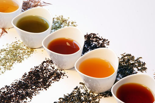 Colorful tea selection - different types of loose tea in small cups