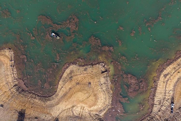 Residents and activists in central Bosnia clean up a lake after massive