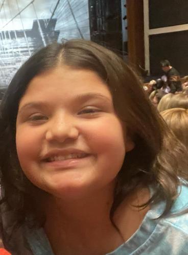 Girl struck by car while waiting for bus remains in hospital