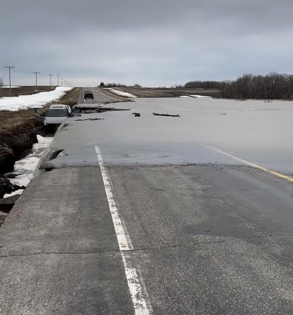 Floodwaters wash out part of Highway 335, vehicle stranded