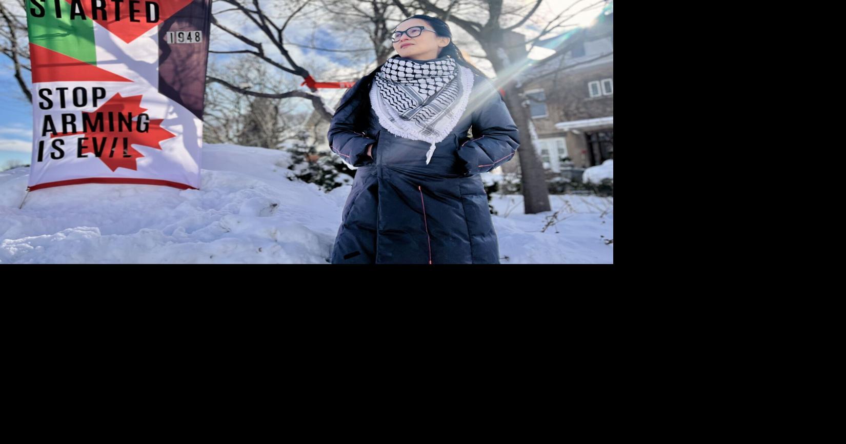 Front yard display includes flags, ribbons and fake white burial shrouds. 