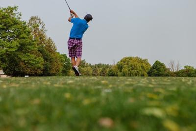 A golfer teeing off