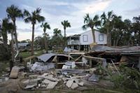 Residents pick through the rubble of lost homes and scattered belongings in  Hurricane Idalia's wake