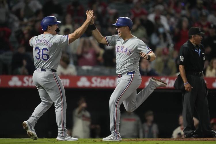 Rangers score four runs in ninth to beat Angels 98