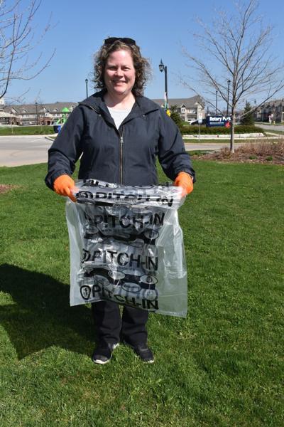 Lori Laird holding waste collection bag