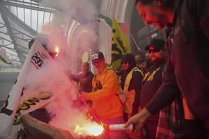 Protesters block roads and start fires across France to challenge the new prime minister, in photos