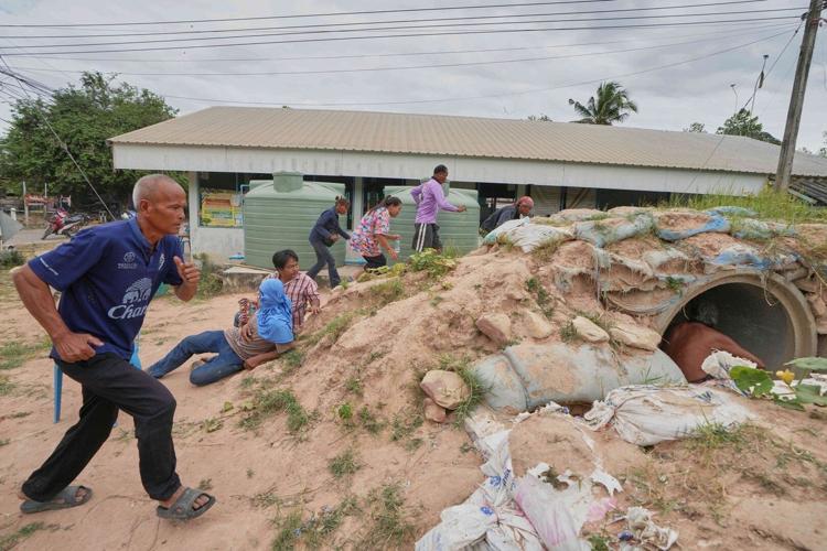 Thai villagers stay behind to guard empty homes as border clashes force ...