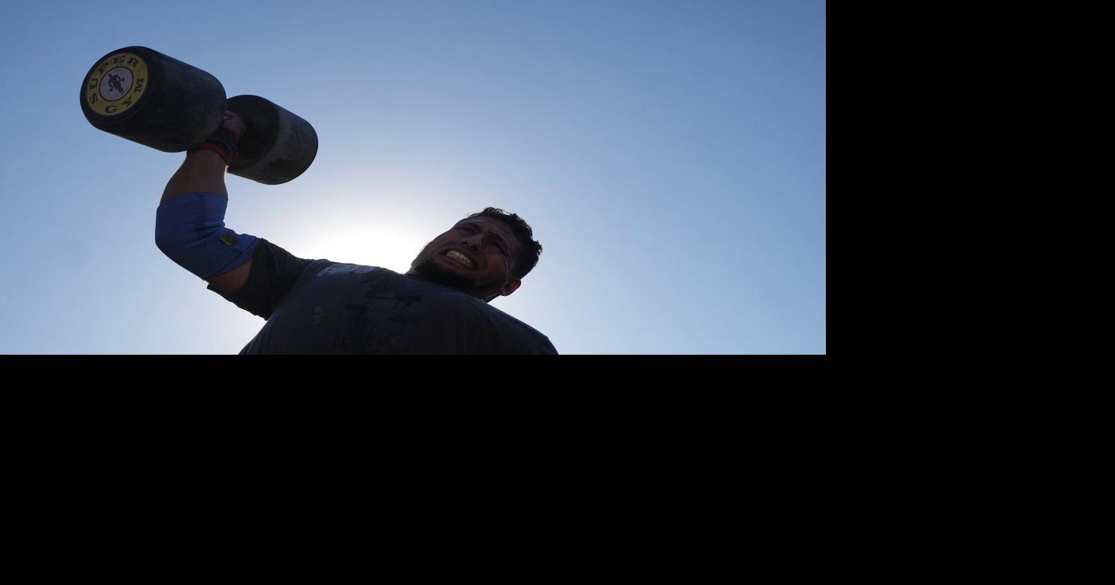 Burly men in Gaza pull trucks and flip tires in competition of strength