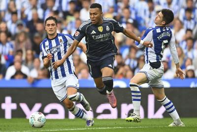 Mbappé leads 10-man Real Madrid to win at Sociedad after Huijsen sees red card